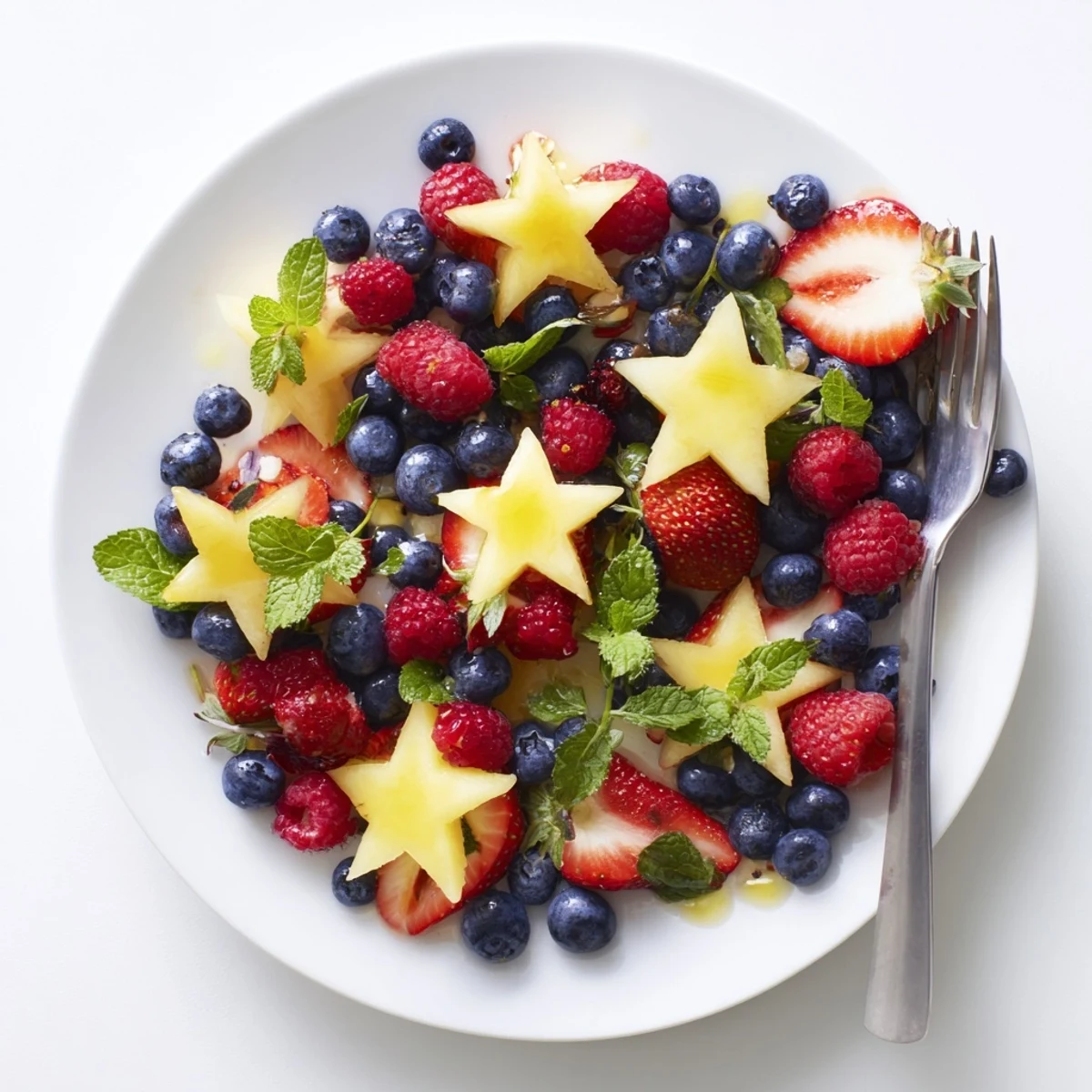 Bright and colorful starfruit and berry platter ready to eat, a refreshing summer snack visually.