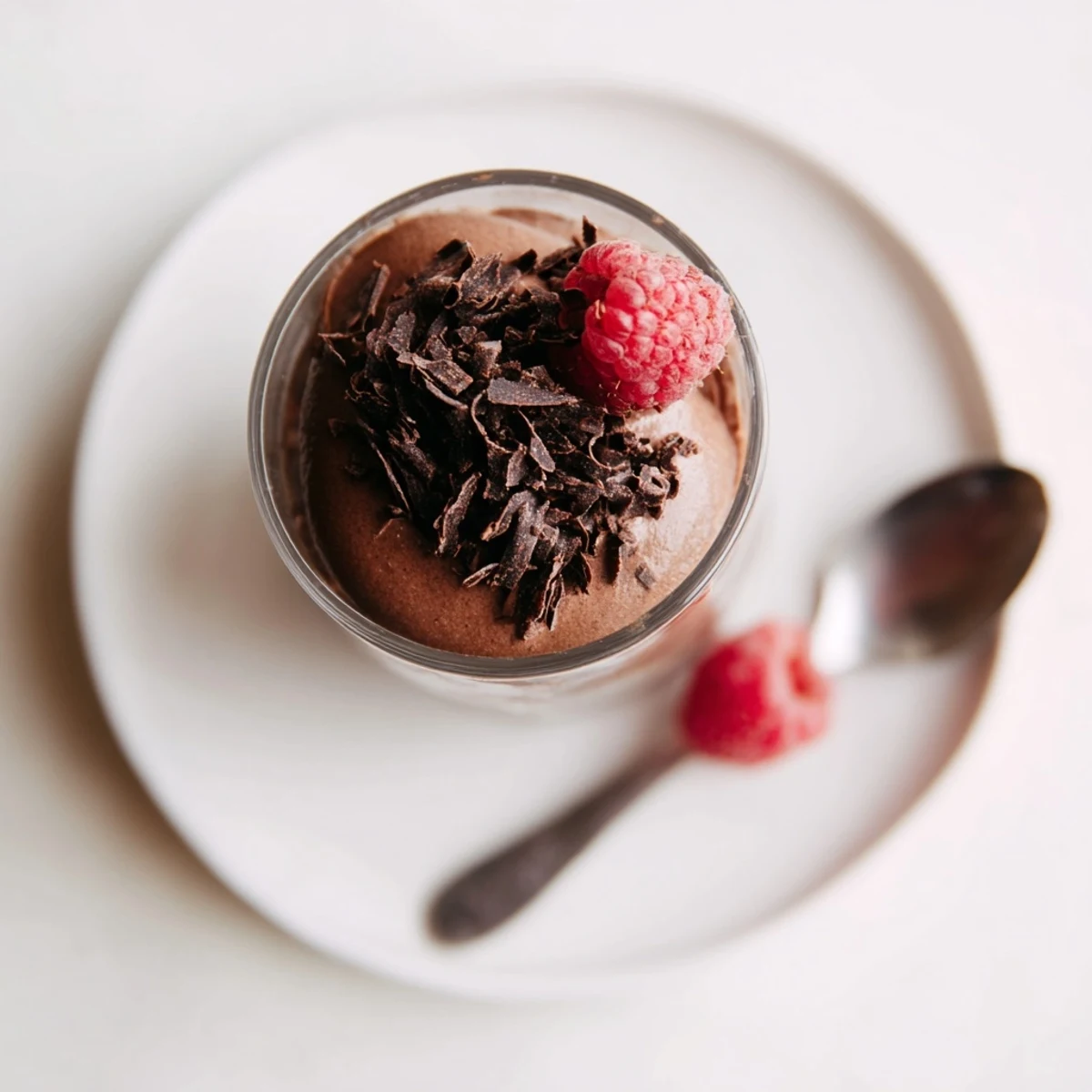 Individual chocolate mousse dessert cups set in shot glasses, promising a smooth, creamy, and delightful treat.