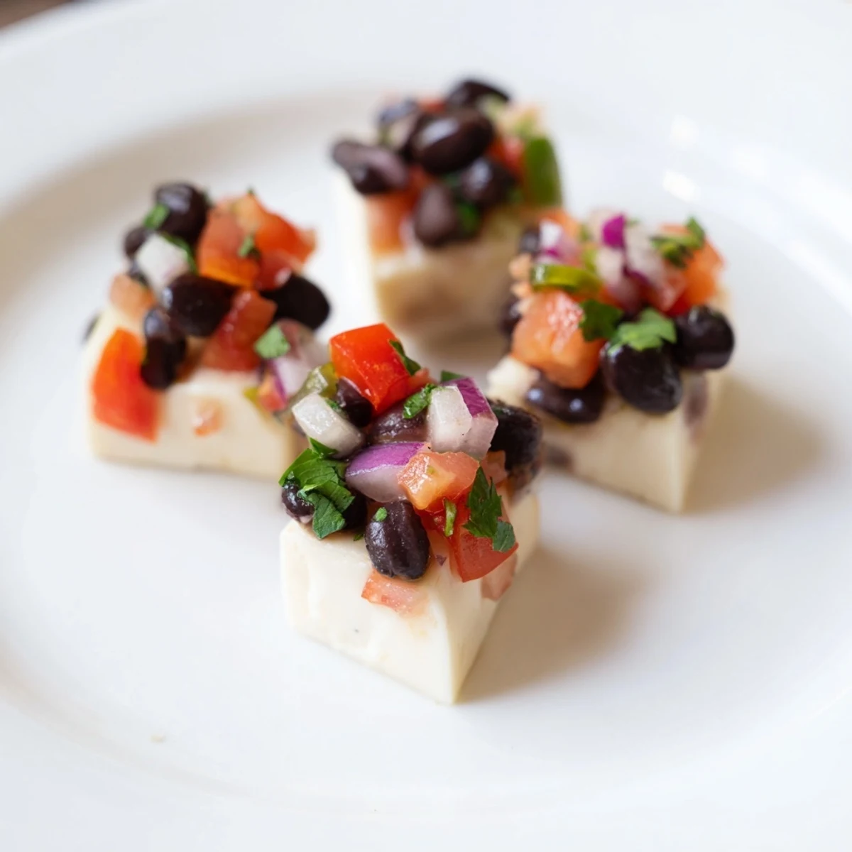 Fresh Pepper Jack cheese cubes alongside vibrant black bean salsa, ready for a delicious appetizer.