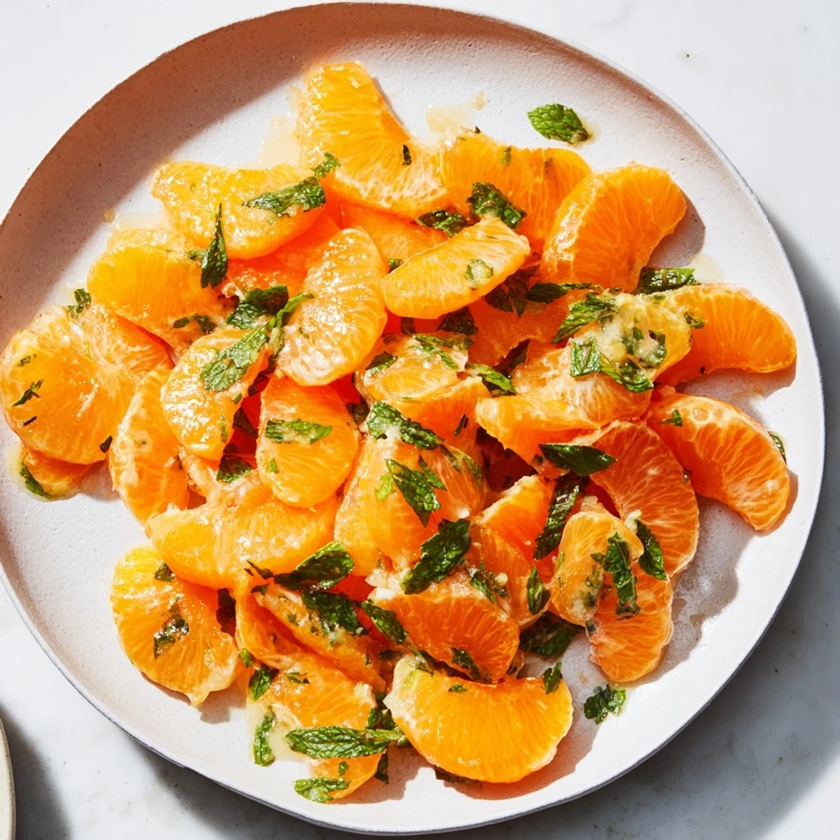 Juicy clementine and mint winter fruit salad, tossed to perfection, ready to refresh your palate.