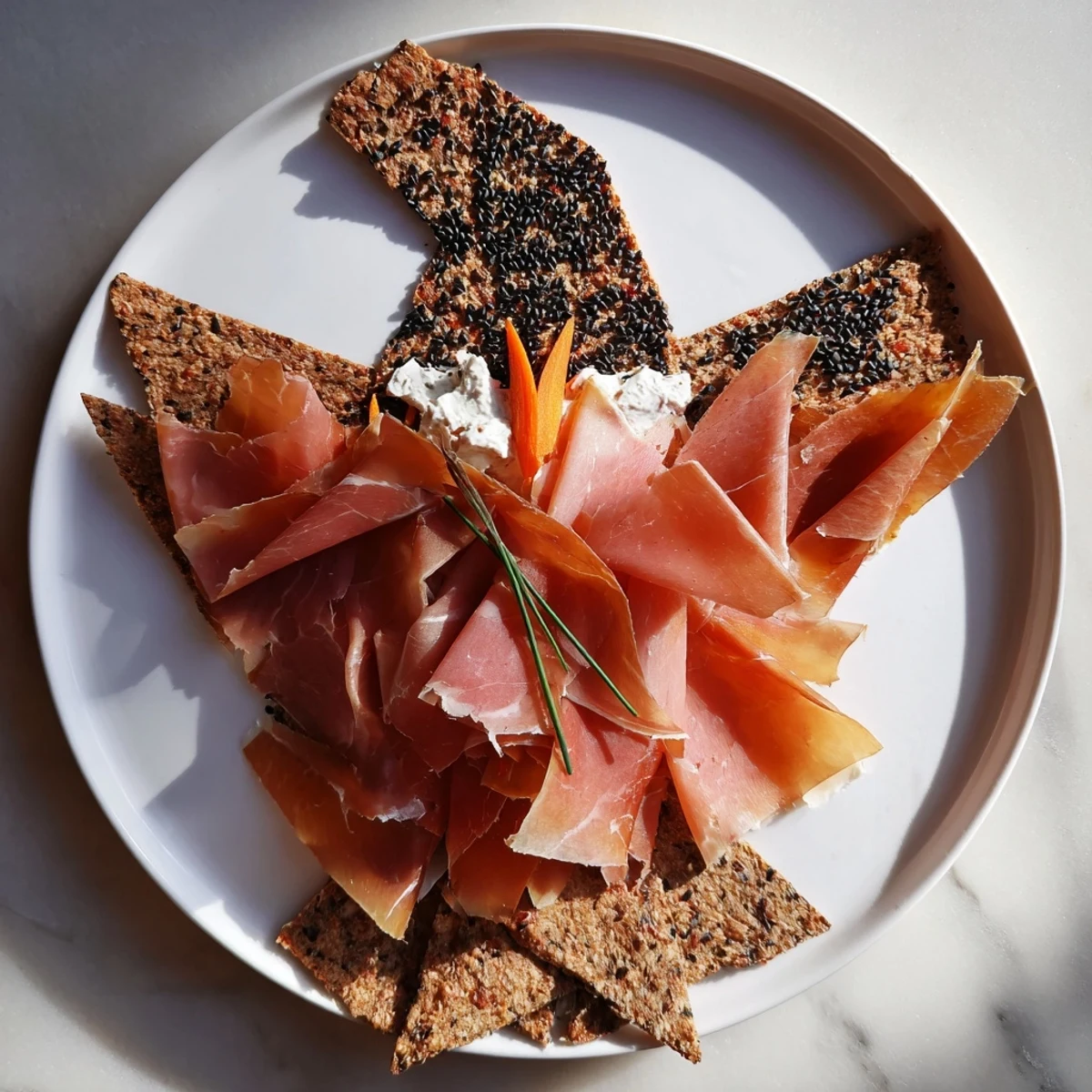 Delicately folded Paper Crane appetizer with cured meats, crispy crackers, and carrot accents, ready to eat!