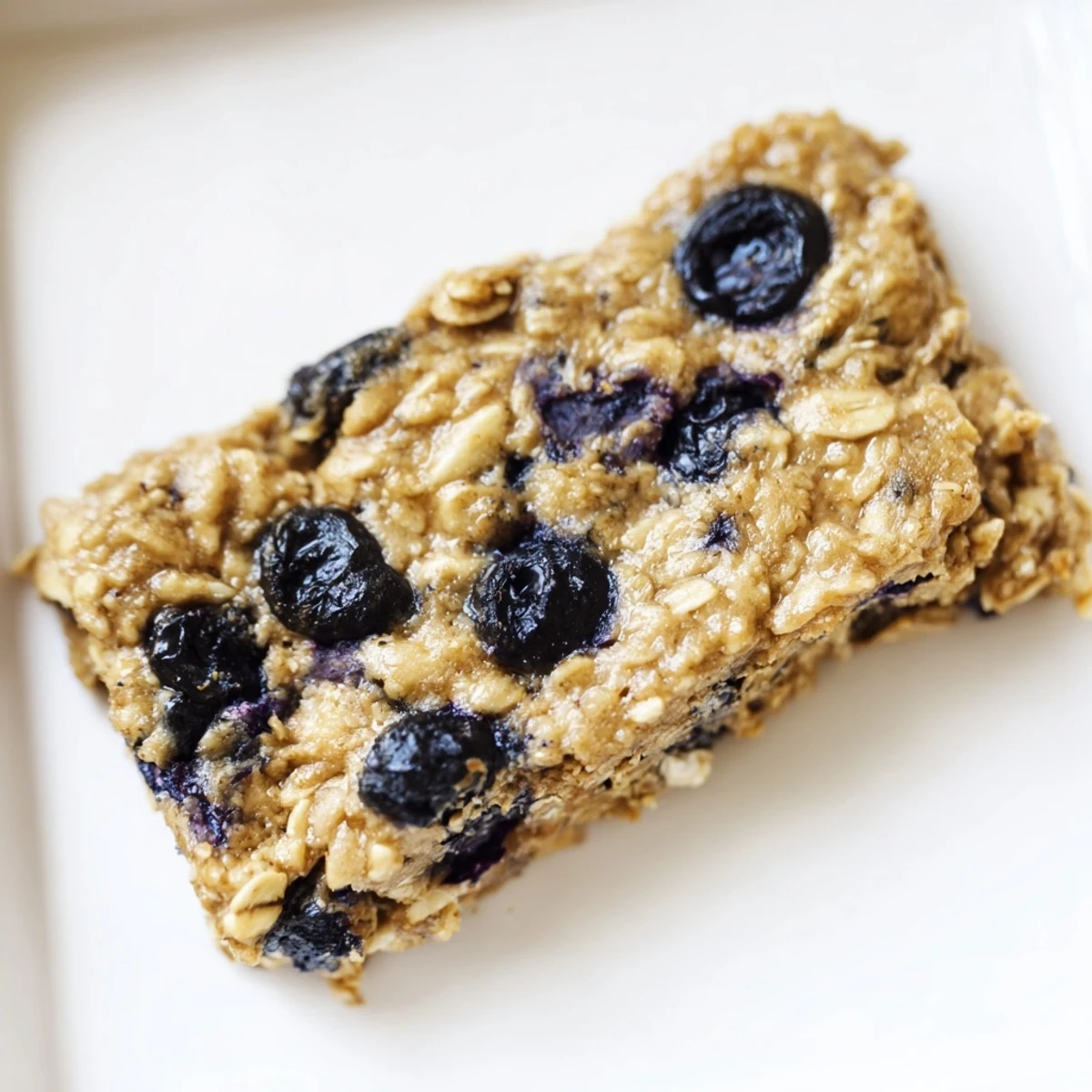 Golden-brown blueberry banana oatmeal protein bars, a healthy breakfast or snack, ready to enjoy.