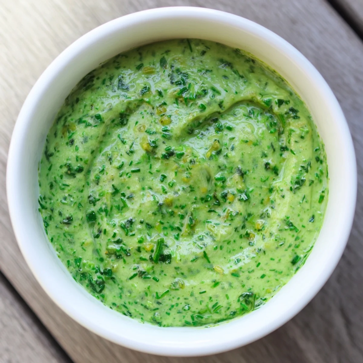 Freshly made Green Goddess Dip, swirled with herbs, ready to be enjoyed with chips or crackers.