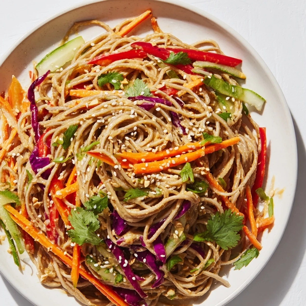 Cold soba noodle salad featuring buckwheat noodles and crisp, crunchy vegetables, perfect for a light meal.