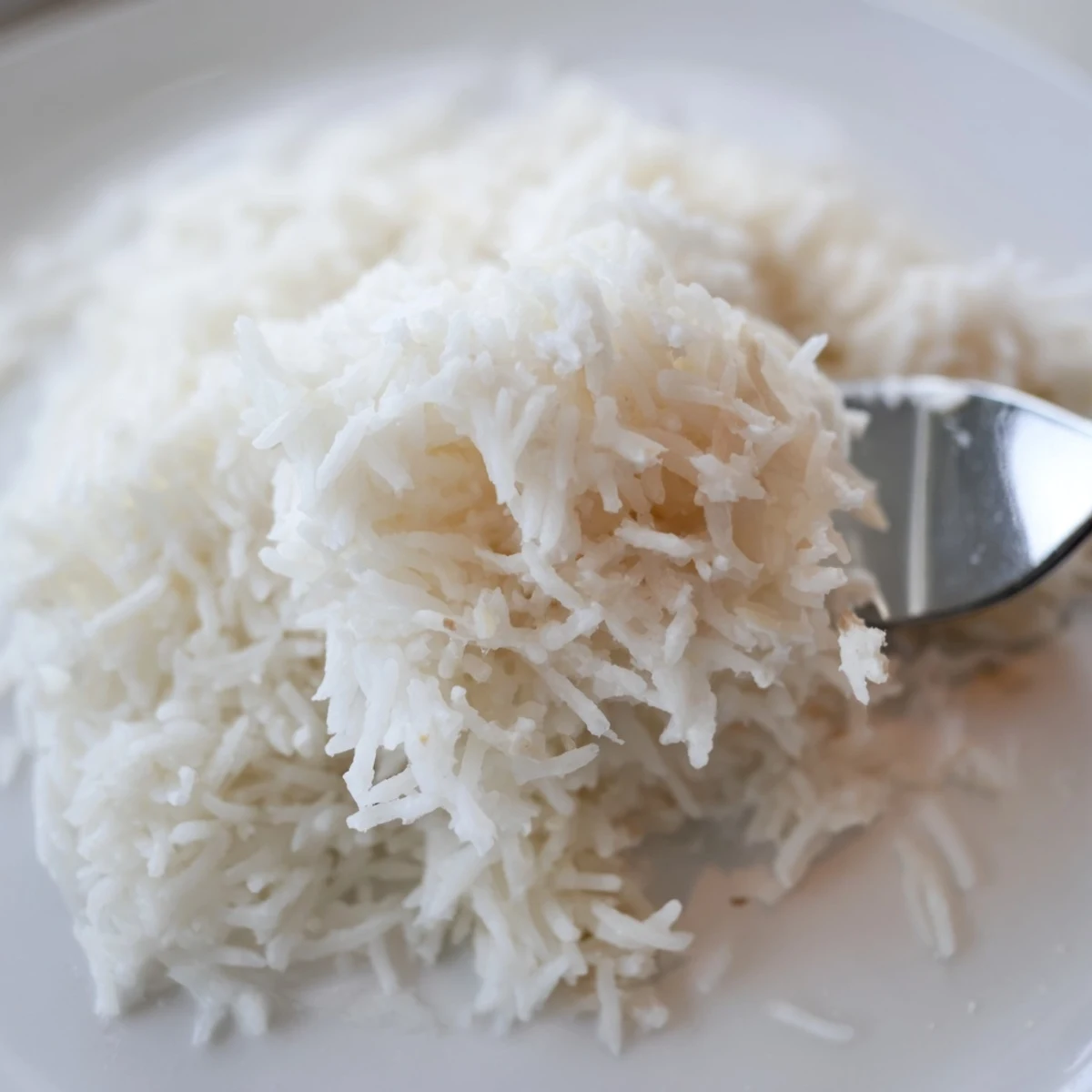Fluffy Coconut Jasmine Rice, steaming hot, ready to serve with fragrant Thai curry, a delicious side.