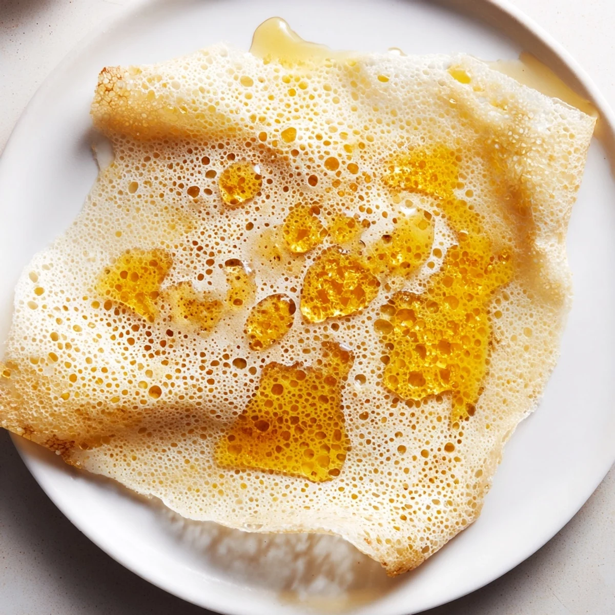 Picture this: a stack of airy Moroccan Baghrir, the perfect soft, spongy North African pancake for breakfast.