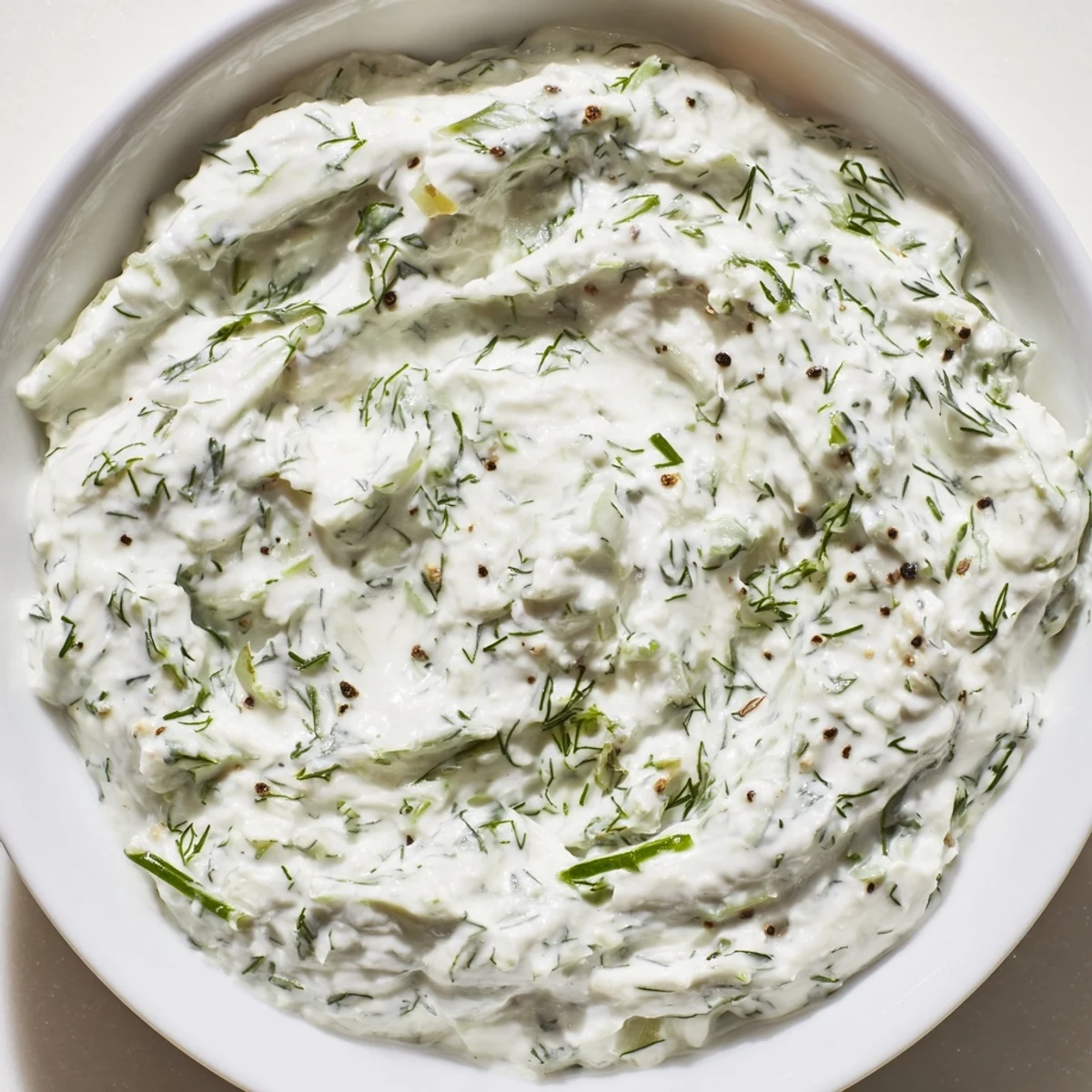 Light and refreshing Greek Yogurt Herb Dip ready to serve, paired with raw veggies and crackers on a bright kitchen counter.