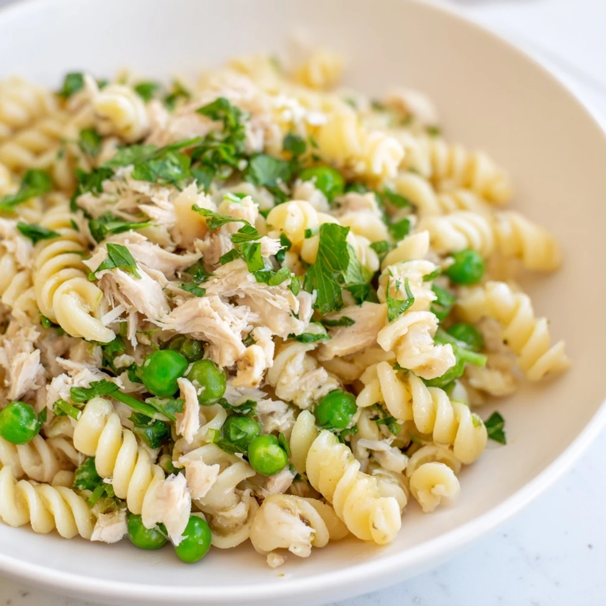 Ready-to-serve Lemony Tuna Pasta Salad garnished with dill and lemon wedges, perfect for a light summer dinner or picnic.