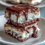 Decadent vanilla sponge layered with silky white chocolate buttercream and a glossy white chocolate drip.