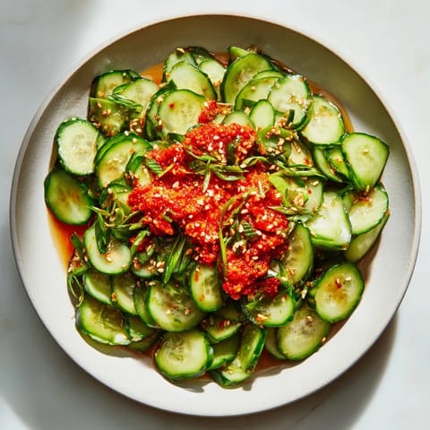 This delightful Cucumber Shaker Salad shows crispy cucumbers glistening with savory chili crisp and sesame seeds.