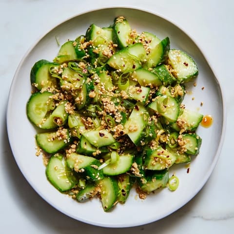 This vibrant Cucumber Shaker features crisp cucumbers tossed in a tangy, umami-rich Asian-inspired dressing.