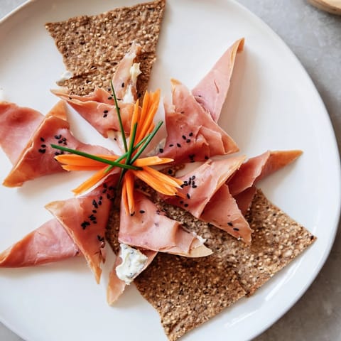 Artfully arranged Paper Crane, a stunning appetizer showing cured meats in a graceful crane shape.