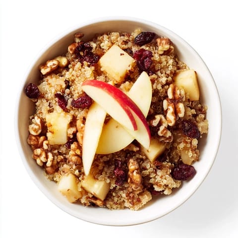 Steaming Apple Cinnamon Quinoa Bowl, a healthy breakfast featuring apples and aromatic spices.