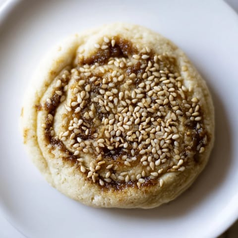 A close-up of beautifully shaped Palestinian Kahk cookies, showcasing their tender texture and date filling.