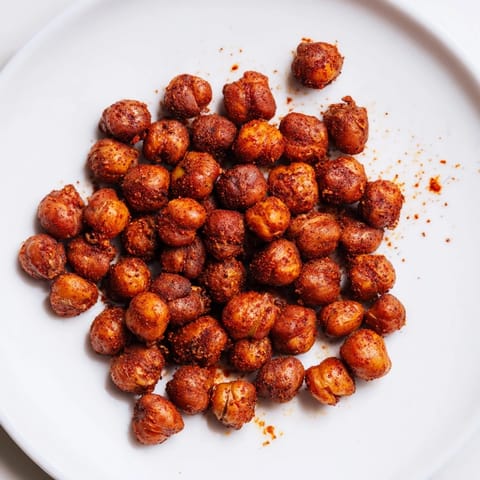 Healthy Crispy Chickpea Snack in a clear glass jar, seasoned with bold spices, ready for on-the-go snacking or parties.