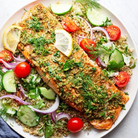 A vibrant plate of Lemon Herb Salmon Salad featuring tender salmon, fresh herbs, cucumber slices, and a bright citrus dressing ready to serve.  
