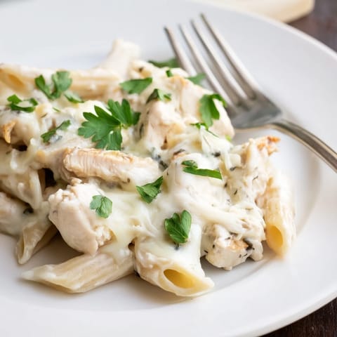 Creamy Chicken Alfredo Casserole with penne pasta and tender chicken, ready to serve.