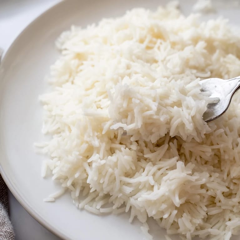 A bowl of creamy Coconut Jasmine Rice, garnished and presented, a visually inviting Southeast Asian side.
