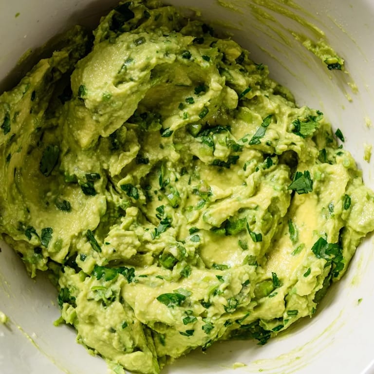 Smooth homemade Avocado Lime Dip with fresh ingredients, perfect for a gluten-free party appetizer or sandwich spread.