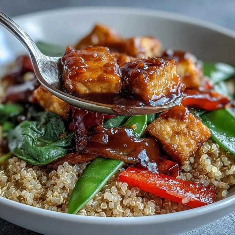 Colorful stir-fry vegetables and quinoa base, garnished with sesame seeds and scallions, ready to enjoy as a gluten-free dinner.